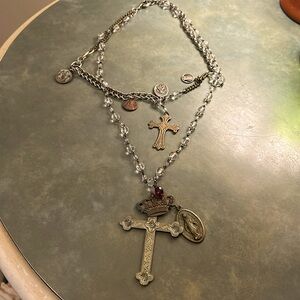 Artisan cross necklace with many saints.